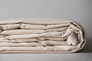 Organic cotton duvet cover in natural color folded for storage