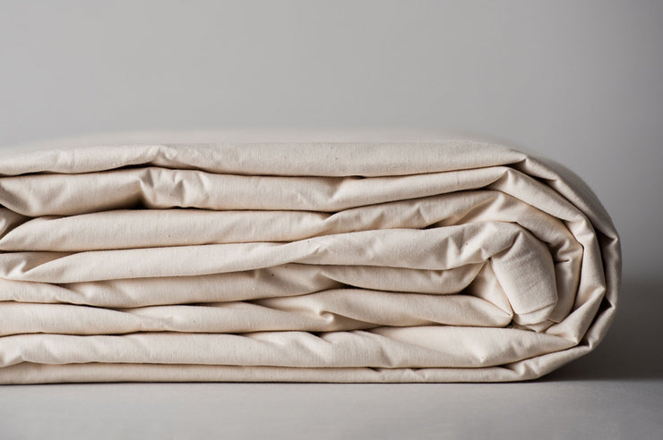 Organic cotton duvet cover in natural color folded for storage