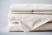 folded organic cotton sheet set in natural color.